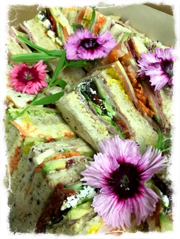 Gourmet point sandwiches cut into triangles and arranged on a platter — Garnishes working lunch catering