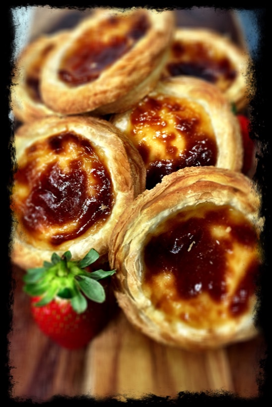 Assorted mini fruit and custard tarts on a serving board — Garnishes working lunch catering